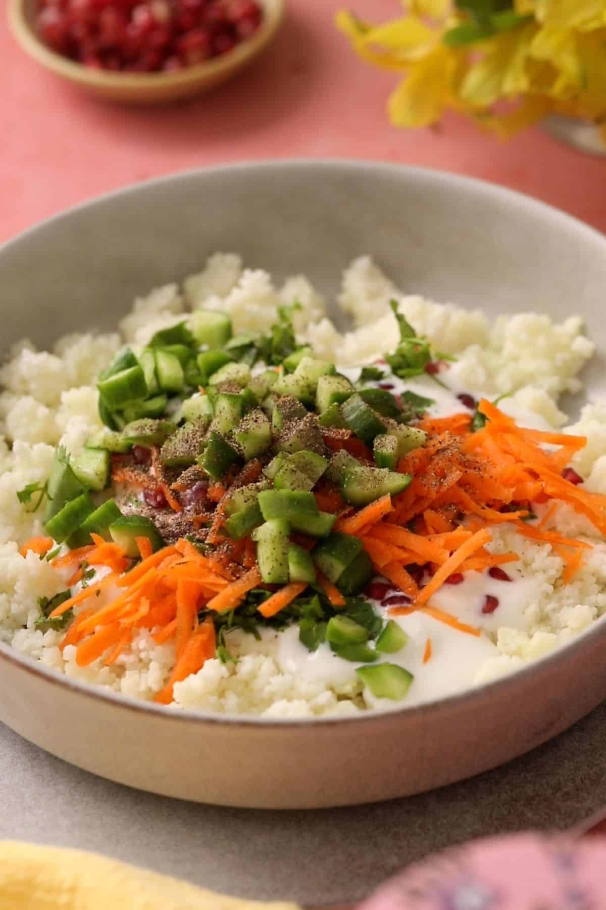 Vegetables are added to samo rice and yogurt.