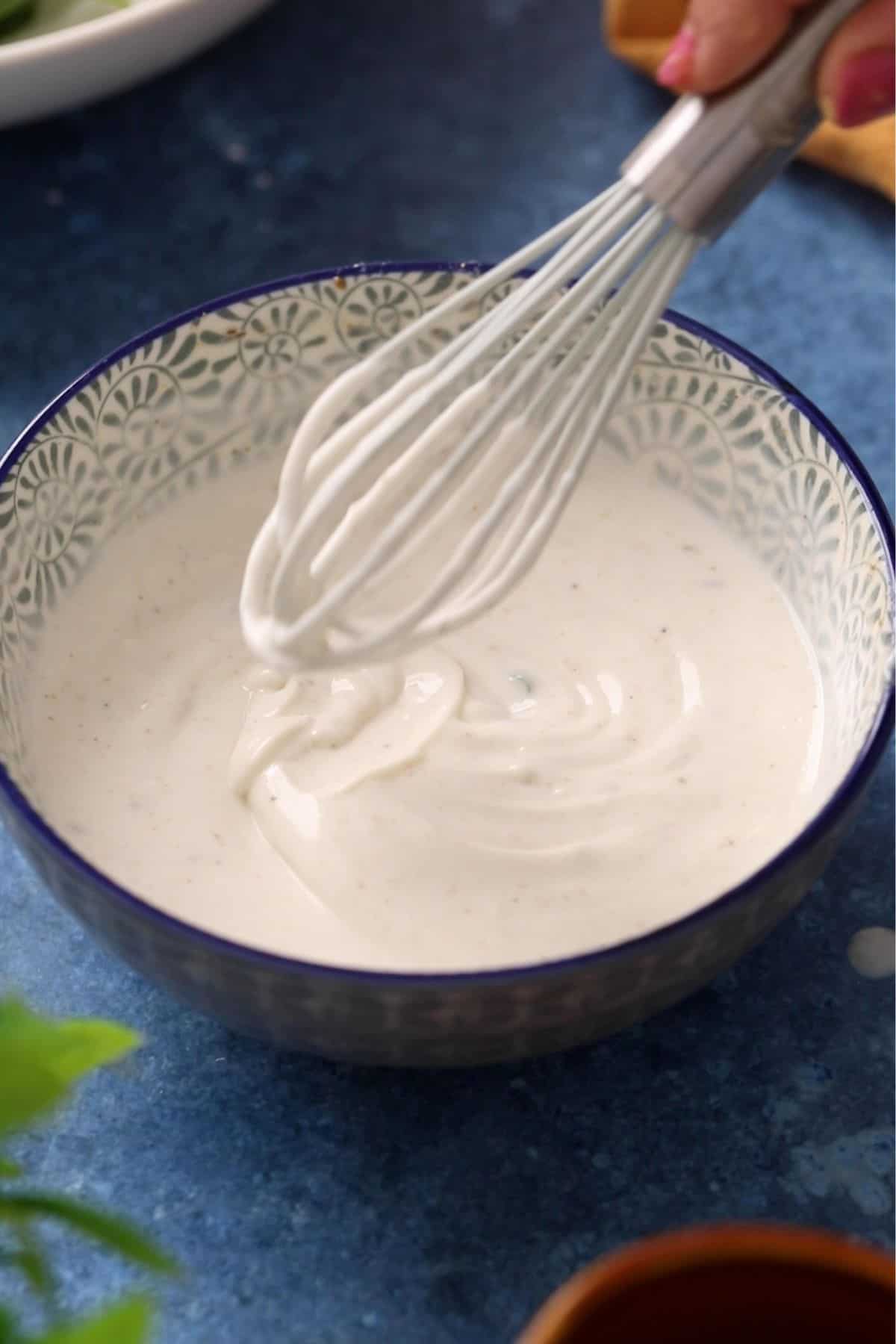 Yogurt is whisked until smooth.