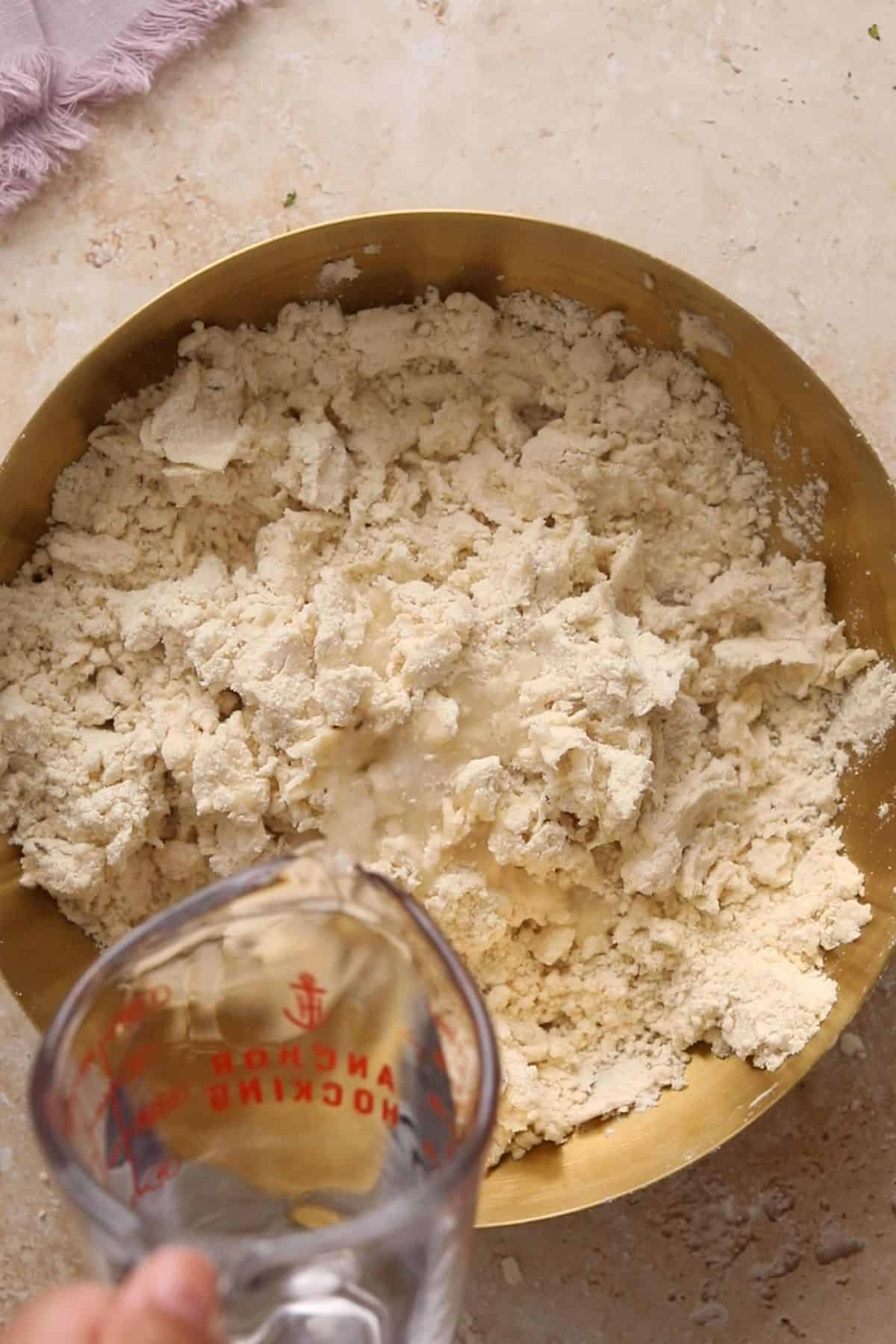 Water is slowly added to flour mixture.