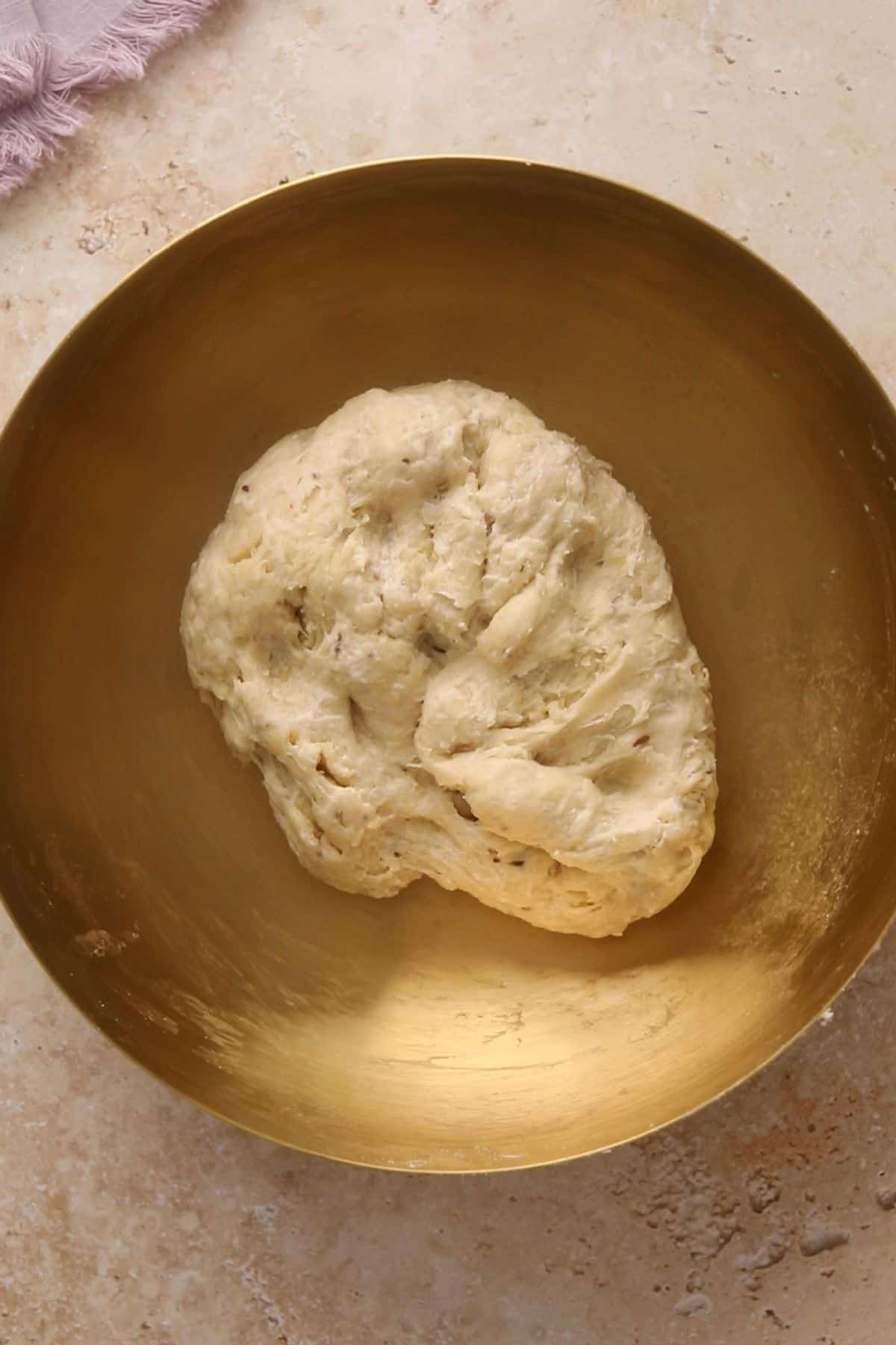 Samosa pastry dough in a gold mixing bowl.