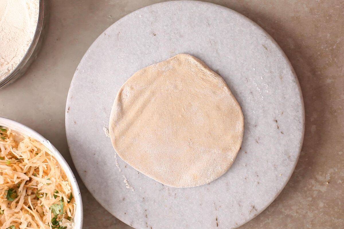 Dough is rolled on a marble rolling surface.