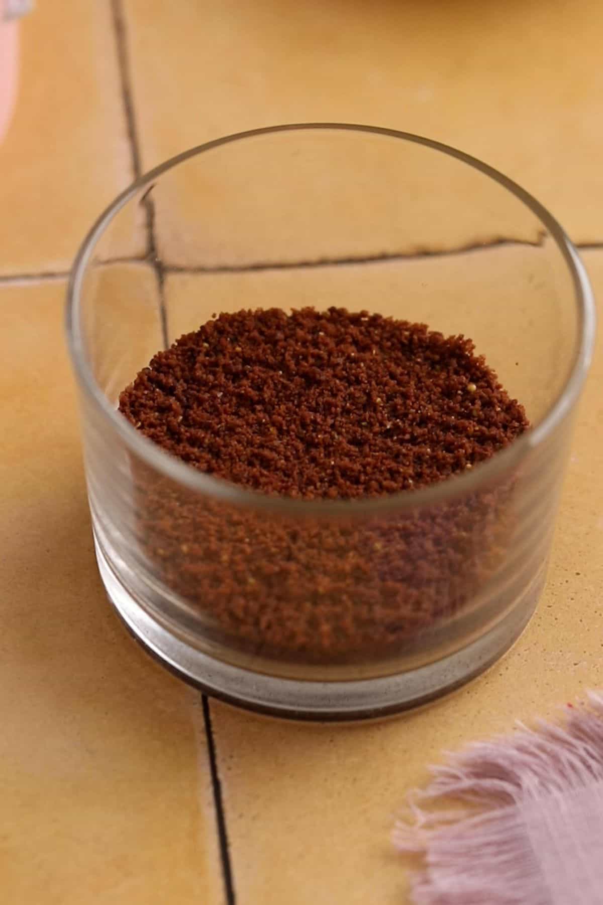 Cookie crumbs placed in a small dessert cup and pressed down.