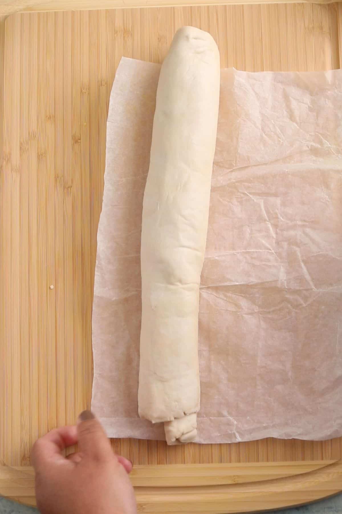 A long roll of puff pastry filled with hara bhara filling.