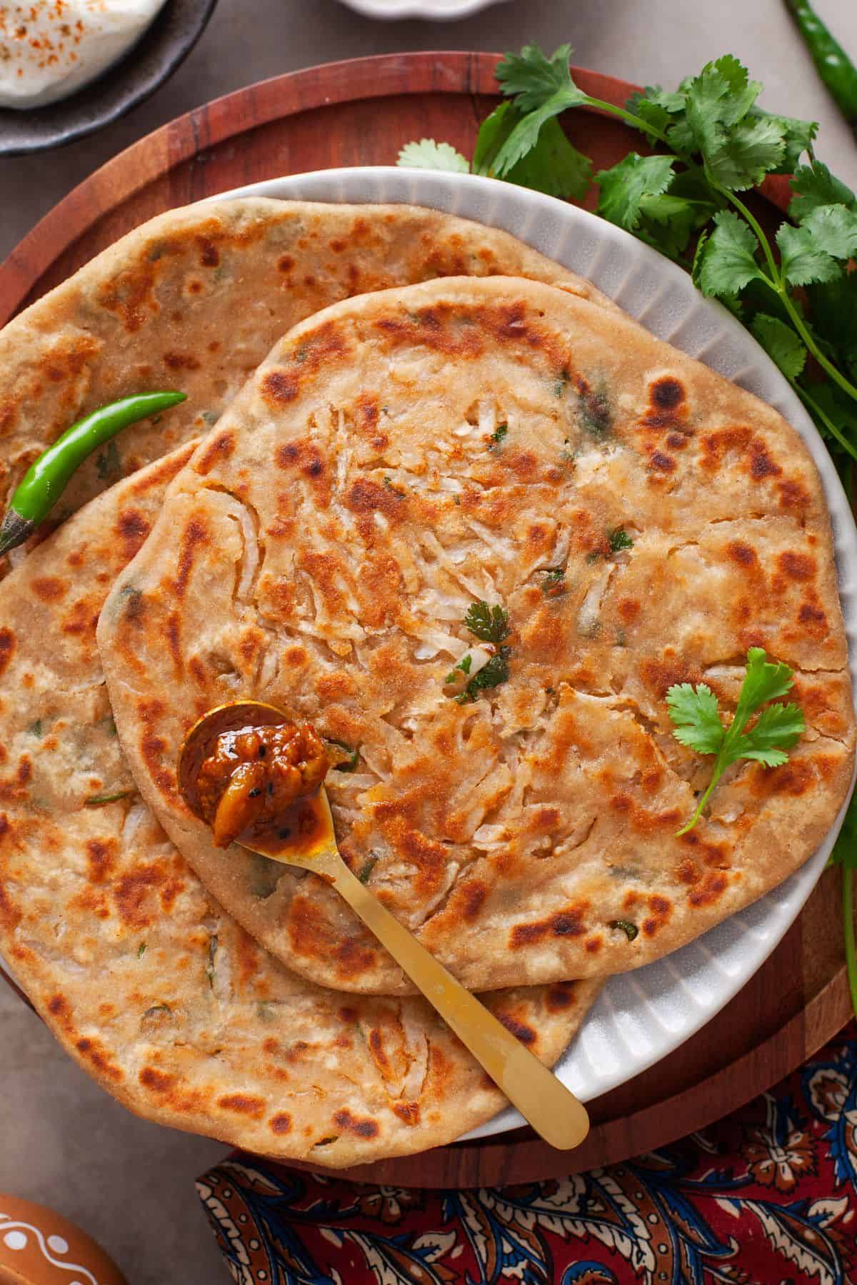 Closeup on mooli aratha placed on a wooden stand. 