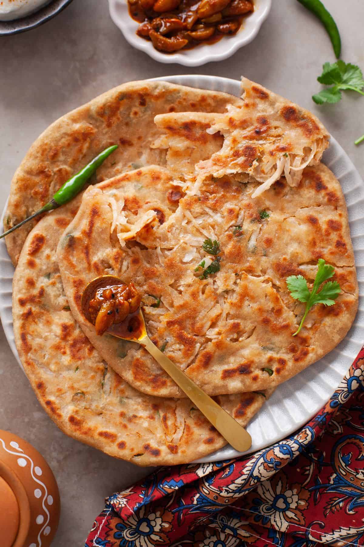 Closeup of torn mooli paratha. 
