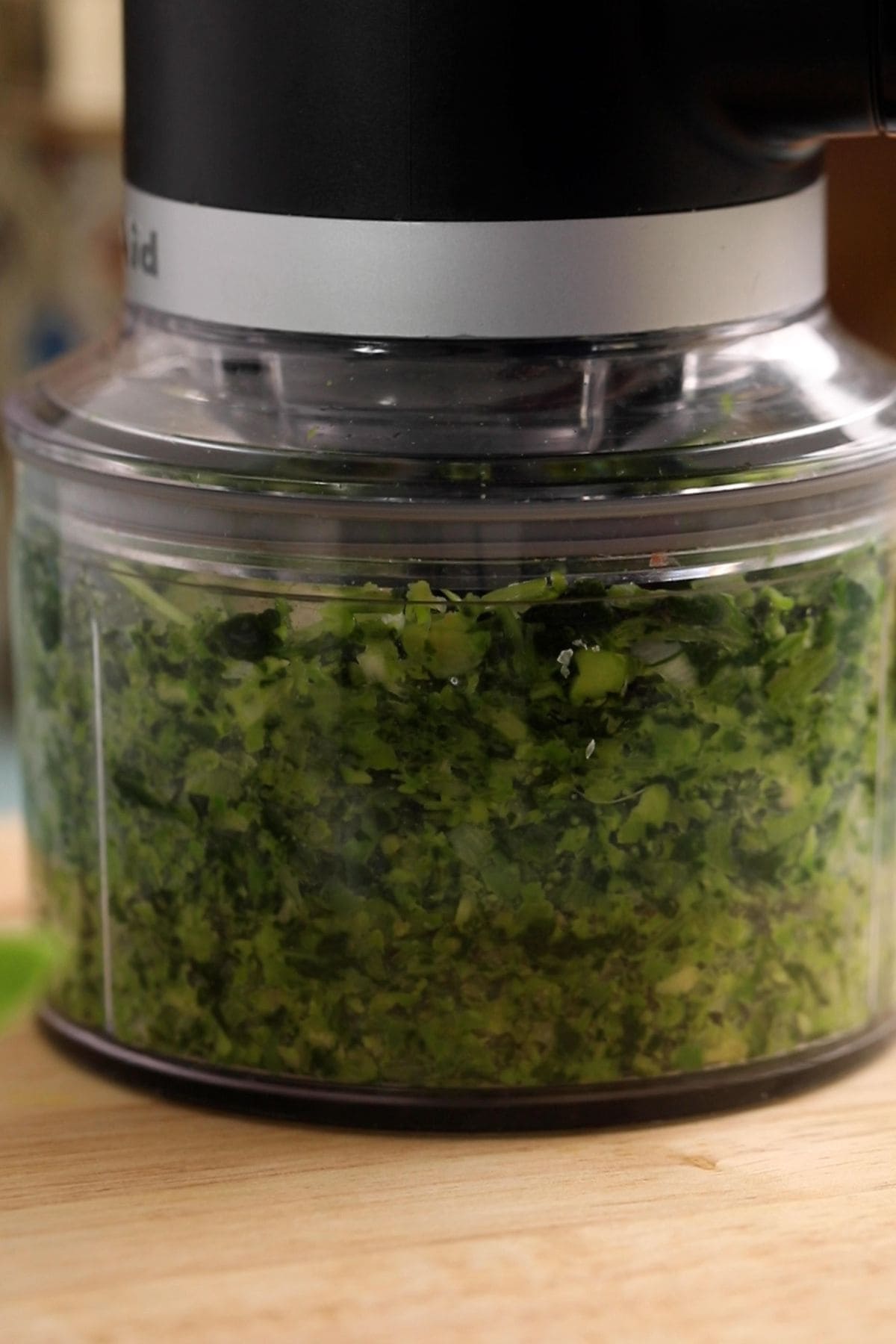 Green vegetables are processing in a processor.
