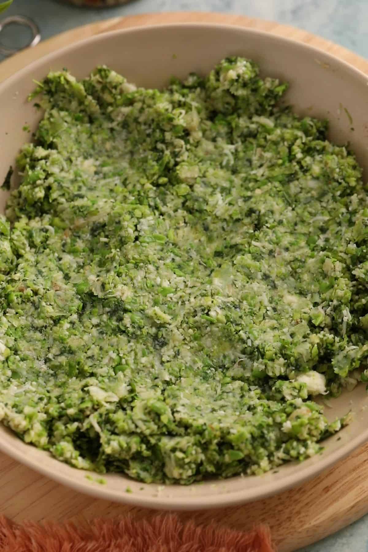 Green vegetable paste in a beige bowl.