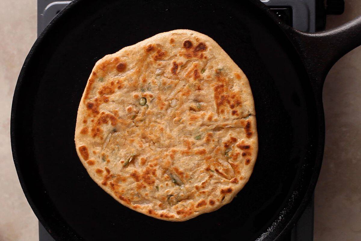Mooli paratha has golden spots and is nicely toasted.