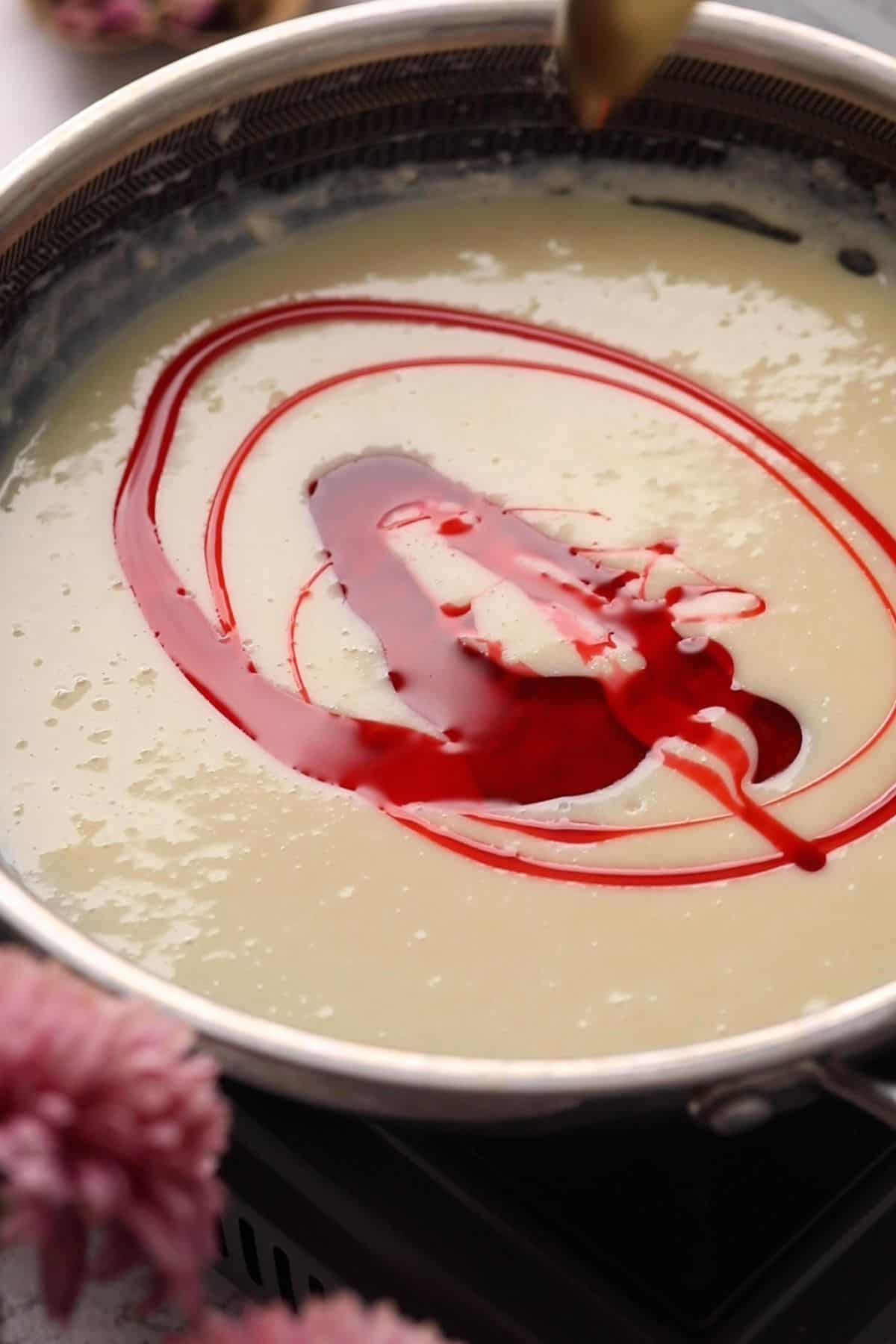 Rose syrup is added to milk mixture.